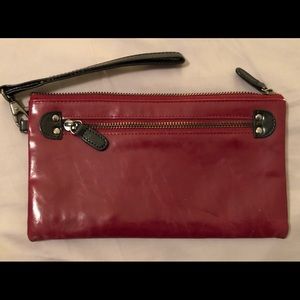Vegan leather clutch in deep maroon with black accents by Shiraleah